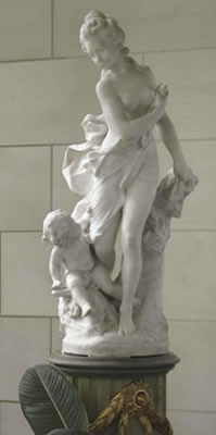 A FRENCH WHITE MARBLE GROUP OF A NYMPH AND A PUTTO ON PEDESTAL