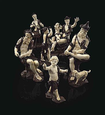 A GROUP OF SIX CARVED IVORY AND WALNUT FIGURES OF BEGGARS