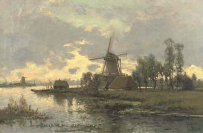 Windmills along a river in late afternoon