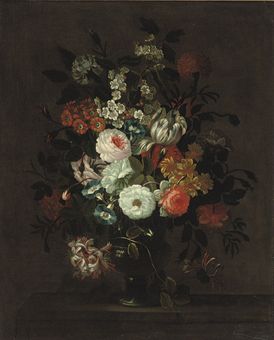 Roses, tulips, morning glory and other flowers in a glass vase on a ledge
