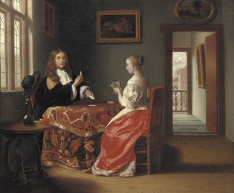 An elegant couple playing cards