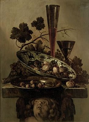 A porcelain bowl with walnuts, a pewter dish with hazelnuts and a 'Façon de Venise', all on a cherub styled pedestal