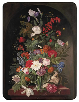 Pink roses, peonies, lilies and various other flowers in a glass vase on a marble edge in a stone ledge