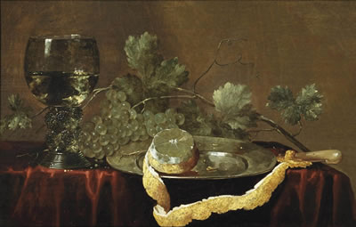 A partially peeled lemon on a silver platter, a knife, grapes and a 'roemer' of white wine on a draped table
