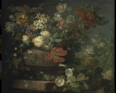 Red and white roses, tulips, blossom and other flowers, in a sculpted vase, on a stone ledge