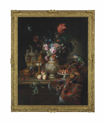 Roses, carnations, morning glories and flowers in a parcel-gilt vase, a nautilus shell goblet, a parcel-gilt two handled cup and porringer, strawberries on a tazza with other utensils with a green parrot and chaffinch on a partly draped stone ledge
