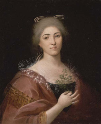 Portrait d'une jeune femme tenant un feuillage