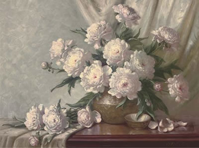 Peonies in a bronze vase on a draped table