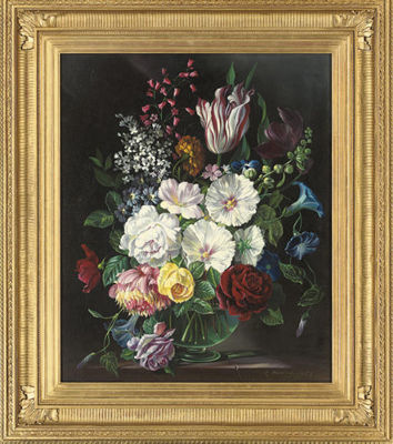 Mixed flowers in a glass vase on a ledge