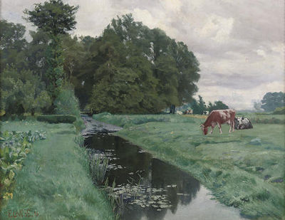 Cows grazing by a waterway