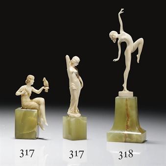 DECO DANCER carved as a female nude poised on one foot and in theatrical pose