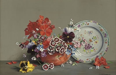 Pansies and other flowers in a bowl, with floral patterned plate to the side