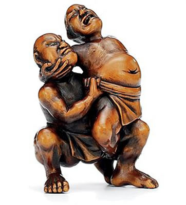 Two sumo wrestlers attempting the Kawazu throw, eyes inlaid in cowhorn