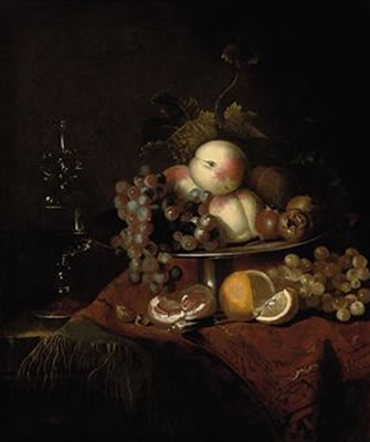 Peaches, grapes and pomegranates on a plate, a sliced orange and walnuts on a partly draped table with a wine glass