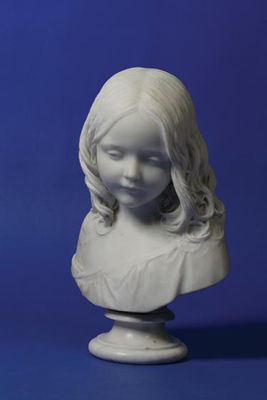 A white marble bust of Mary Isabella Matheson glancing downwards and slightly to sinister