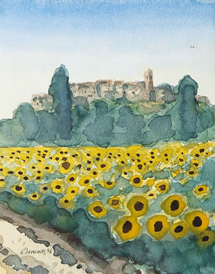 Blick über ein blühendes Sommerblumenfeld auf eine italienische Stadt