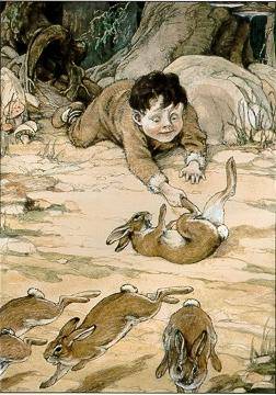 Boy catching rabbit by the foot