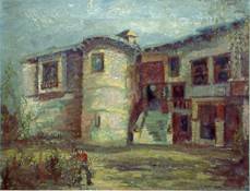 Man tending a garden before an old building