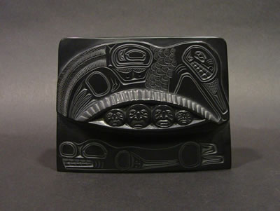 A carved argillite plaque depicting Mankind Emerging from Clam Shell