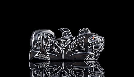 Carved argillite figure depicting Haida Wasgo and Salmon