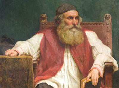 A portrait of a rabbi holding a book.