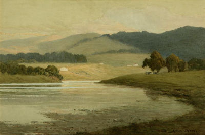 Rolling hills, oak trees and cattle near a river