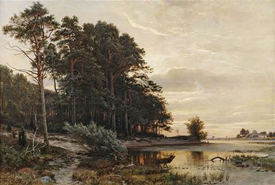 A lake at the border of a wood at evening light.