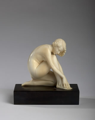 FIGURE OF A NUDE KNEELING WOMAN.