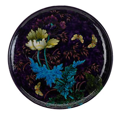 Massive earthenware charger, squeezebag-decorated with poppies and butterflies