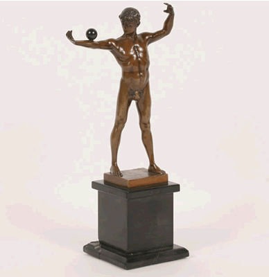 Statue of male balancing ball on forearm