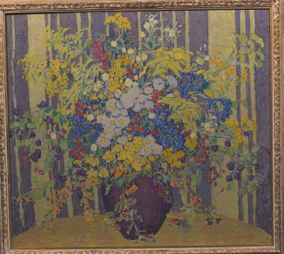 Field flowers in a purple ceramic vase