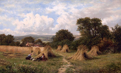 Figures in a field with haystacks