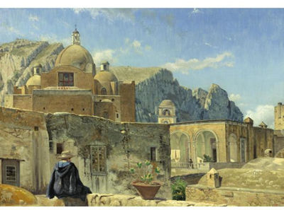 A YOUNG BOY SEATED ON A WALL OVERLOOKING CAPRI