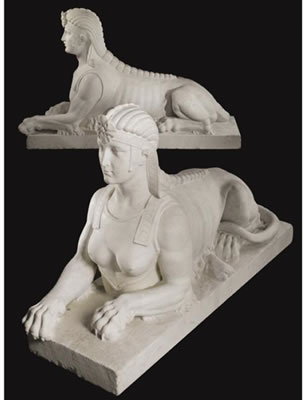 A LARGE PAIR OF CARVED WHITE MARBLE SPHINXES