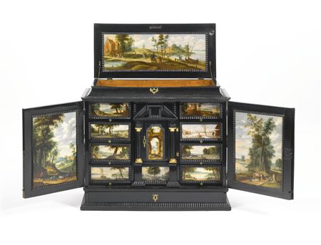 A LATE RENAISSANCE ANTWERP EBONY VENEERED CABINET, CIRCA 1645, WITH VILLAGE LANDSCAPES AND SCENES FROM DAILY LIFE