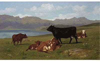 CATTLE GRAZING ON A HILLSIDE WITH A LAKE IN THE NEAR DISTANCE