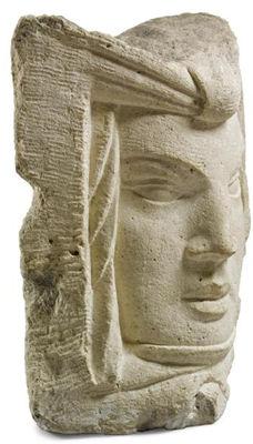 A LARGE STONE HEAD
