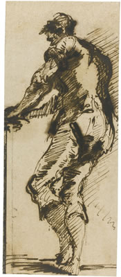 A STANDING MAN AT WORK, HIS HANDS ON THE EDGE OF A TABLE