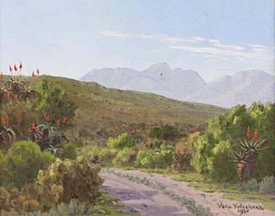 A WINDING ROAD FLANKED BY ALOES