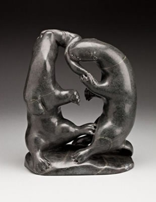 Two otters fighting over a fish