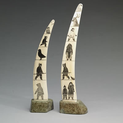 PAIR OF INCISED TUSKS ON BASES