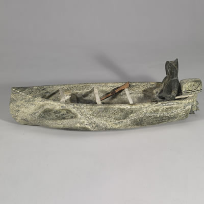 MAN IN BOAT WITH MOTOR AND IMPLEMENTS