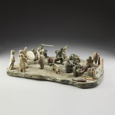 AN INUIT TABLEAU CONSISTING OF A FAMILY DRYING FISH, A DRUM DANCE CIRCLE, POLAR BEAR HUNTING