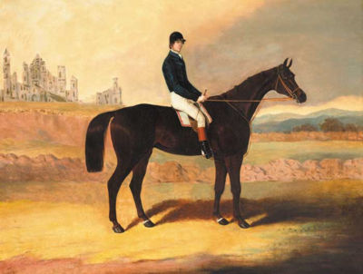 A DARK BAY RACEHORSE WITH JOCKEY UP AND A VIEW OF ABBEY RUINS BEYOND