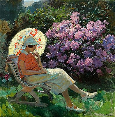 A young woman in the garden with rhododendron in the background.