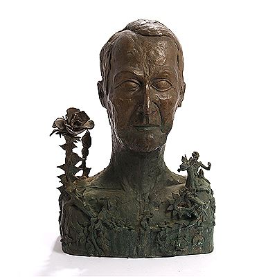 A patinated bronze male bust with fantasy landscape