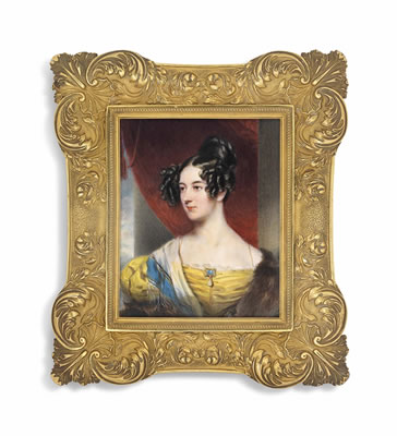 A young lady, in yellow dress with brown fur stole and blue-bordered white scarf, wearing a sapphire and drop-pearl-set brooch at corsage, dark hair dressed in ringlets; red curtain and pillar background