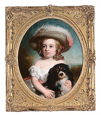 Portrait of a young girl holding a Cavalier King Charles Spaniel