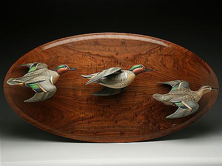 Three carved flying teal mounted on hardwood backboard