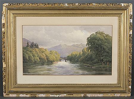 River landscape with bridge and mountains in the distance.